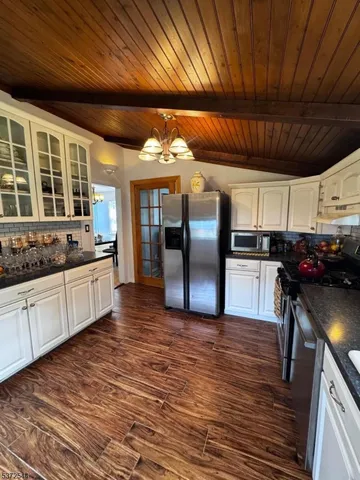 a kitchen with wooden floors and a stove