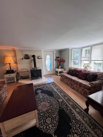 an empty room with windows and fireplace