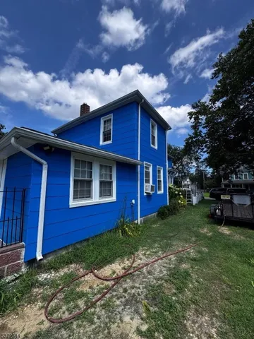 a view of a field with a house in the background