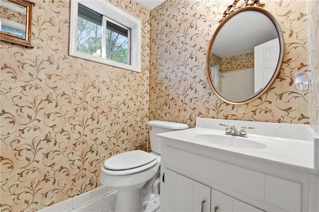 3121 Bonds Lake Road Northwest Conyers, GA 30012 - Photo 21 of 36 a bathroom with a sink a toilet and a mirror