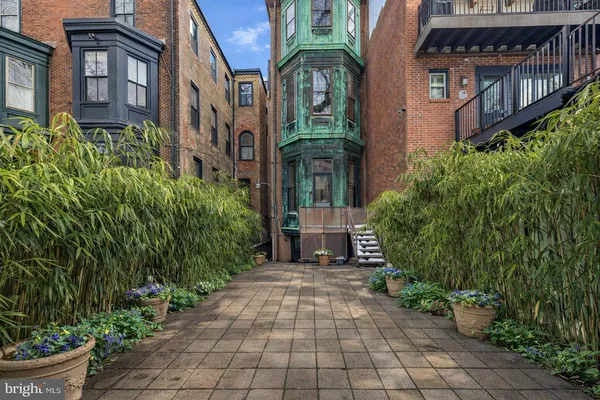 a pathway of a house with a yard