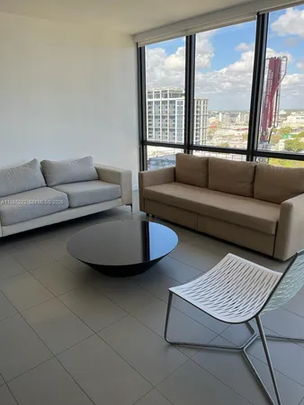 a living room with furniture and a large window