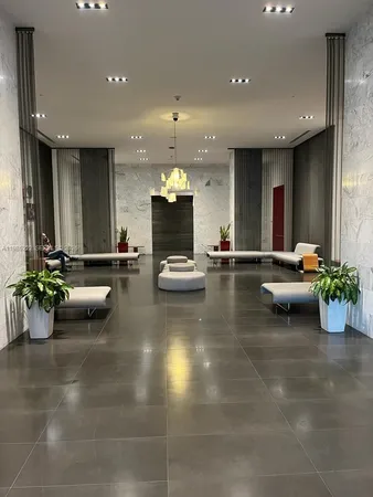 a lobby with furniture and a potted plant