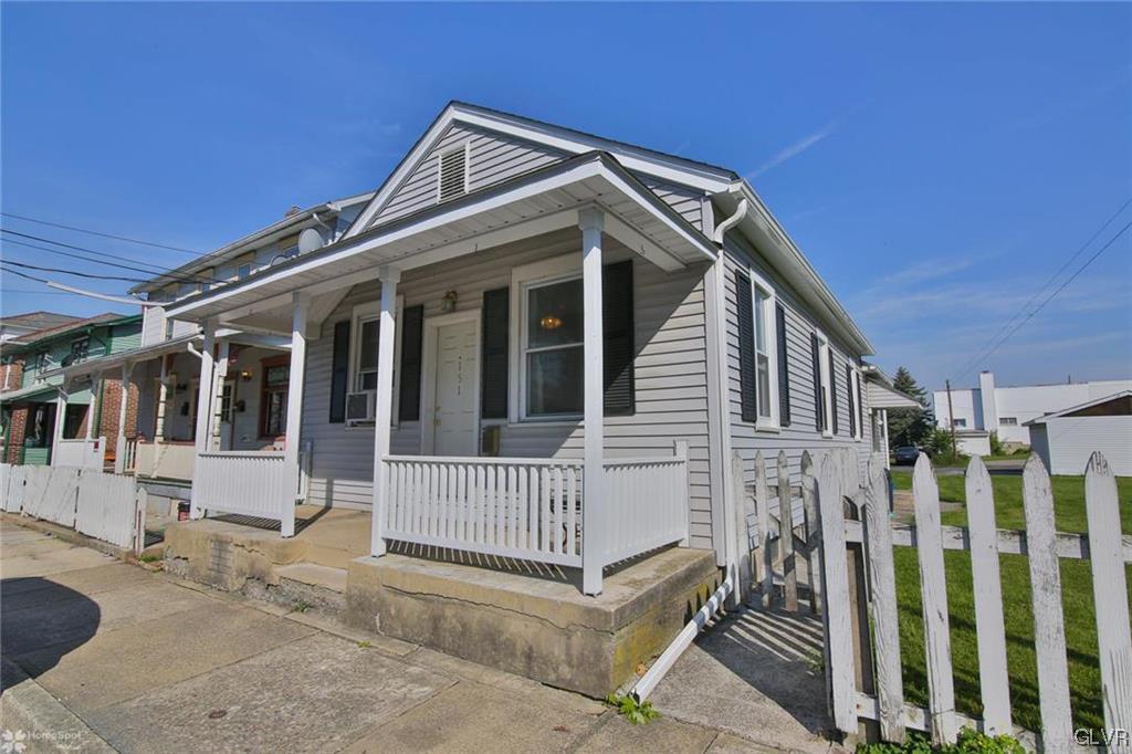 a view of a house with wooden fence