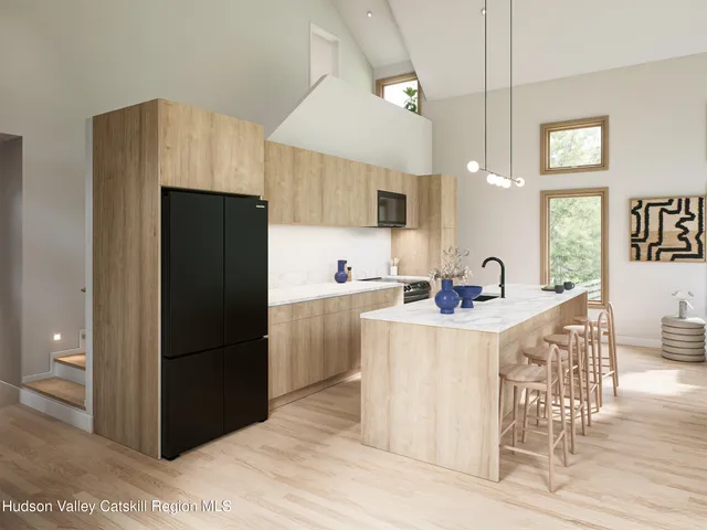 a kitchen with stainless steel appliances a refrigerator stove microwave and white cabinets