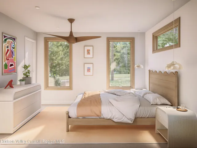 a spacious bedroom with a bed and a window