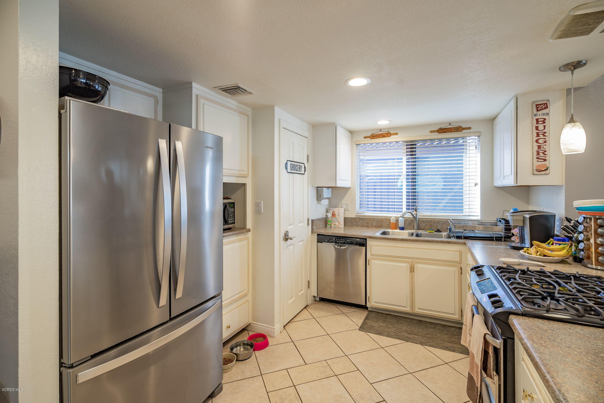 6116 Al Way Simi Valley, CA 93063 - Photo 14 of 55 a kitchen with stainless steel appliances a refrigerator sink and stove