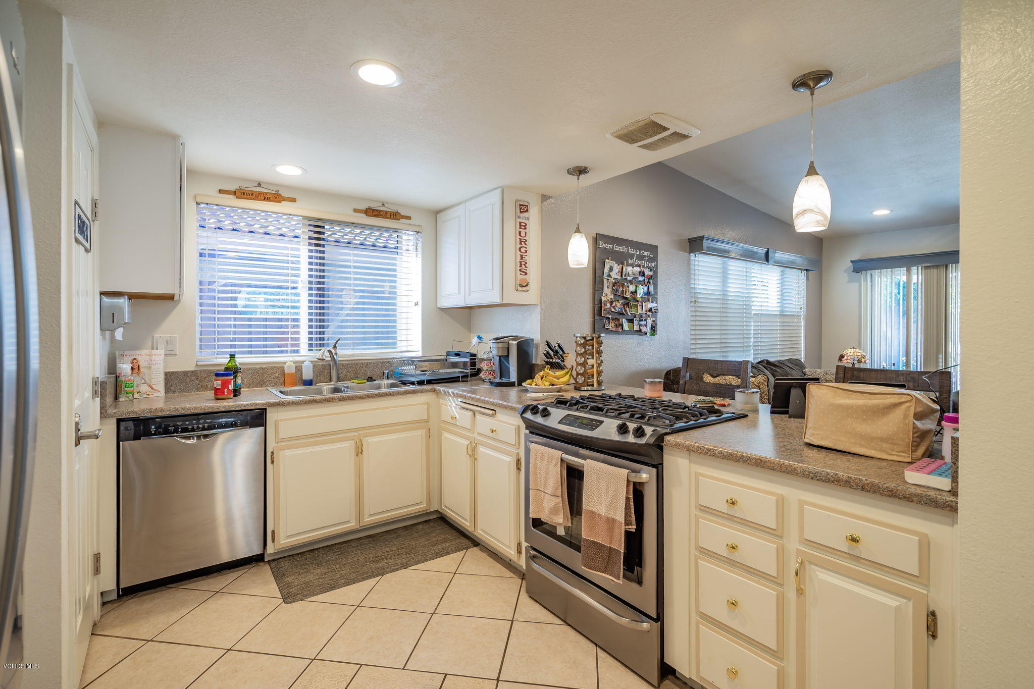 6116 Al Way Simi Valley, CA 93063 - Photo 17 of 55 a kitchen with stainless steel appliances granite countertop a stove a sink and a refrigerator