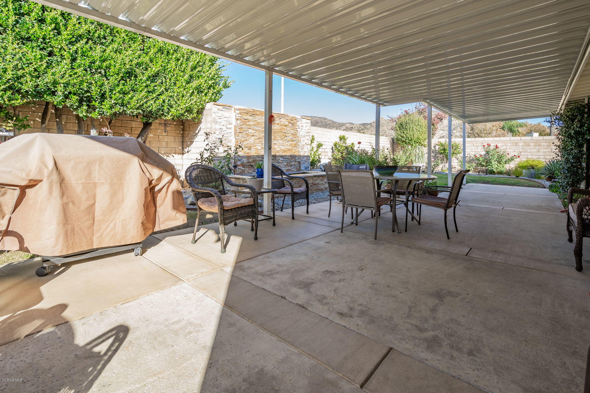 6116 Al Way Simi Valley, CA 93063 - Photo 39 of 55 a view of a patio with table and chairs potted plants and large tree