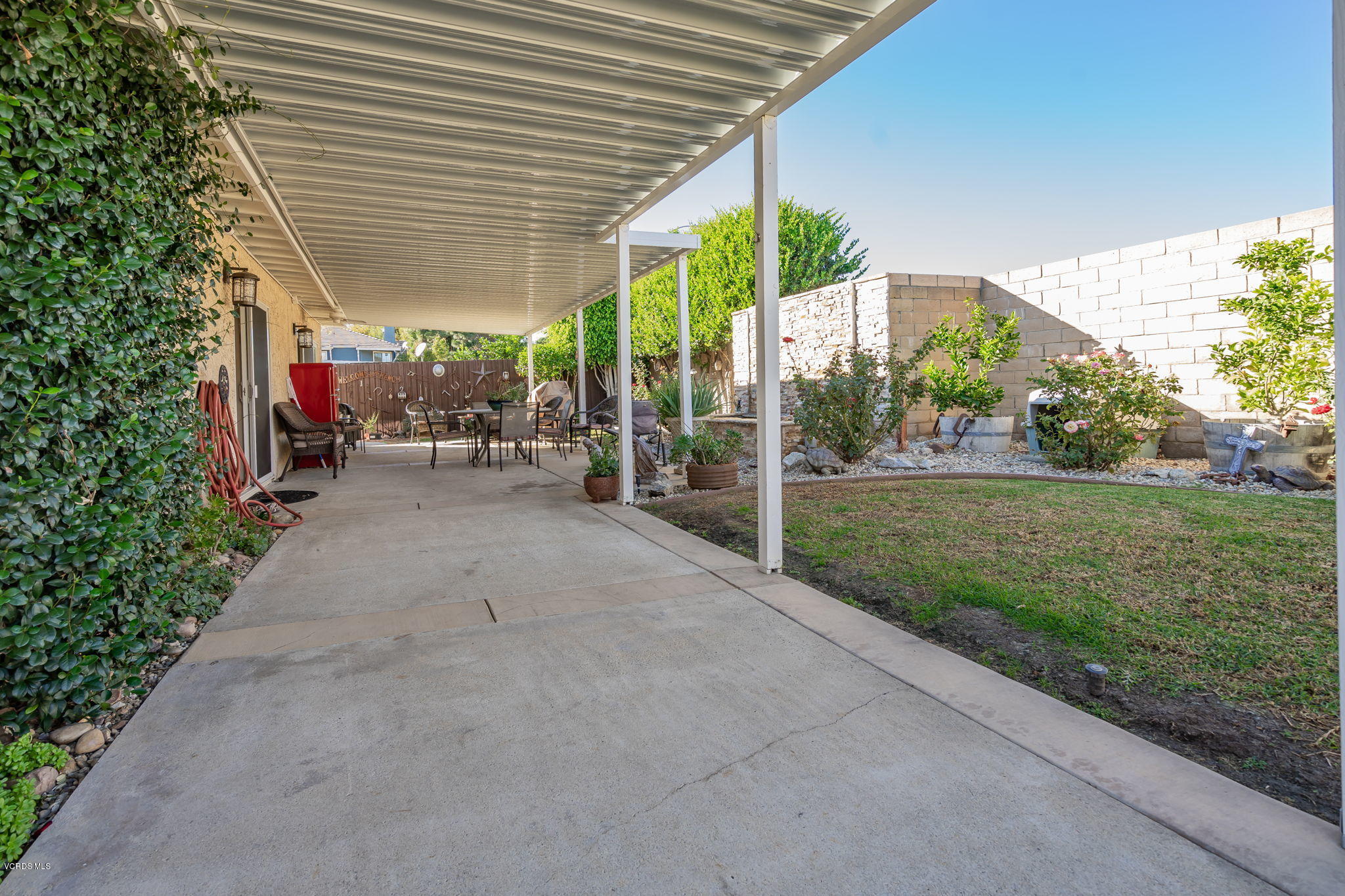 6116 Al Way Simi Valley, CA 93063 - Photo 42 of 55 a view of a patio with a table and chairs under an umbrella