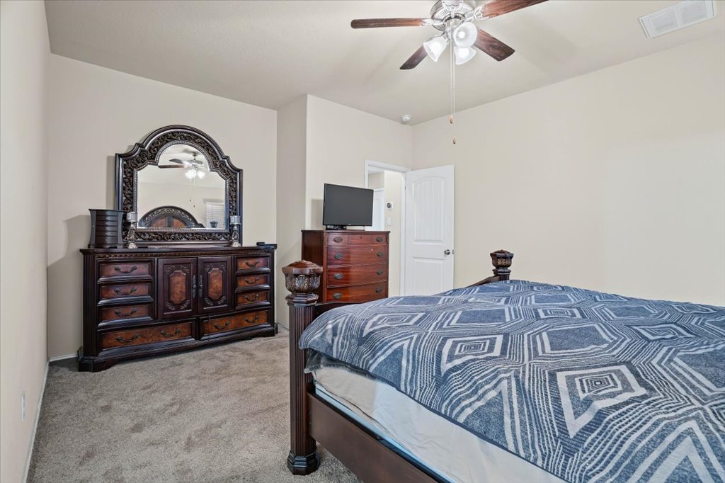 212 Plata Lane Jarrell, TX 76537 - Photo 17 of 30 Bedroom featuring carpet floors and a ceiling fan