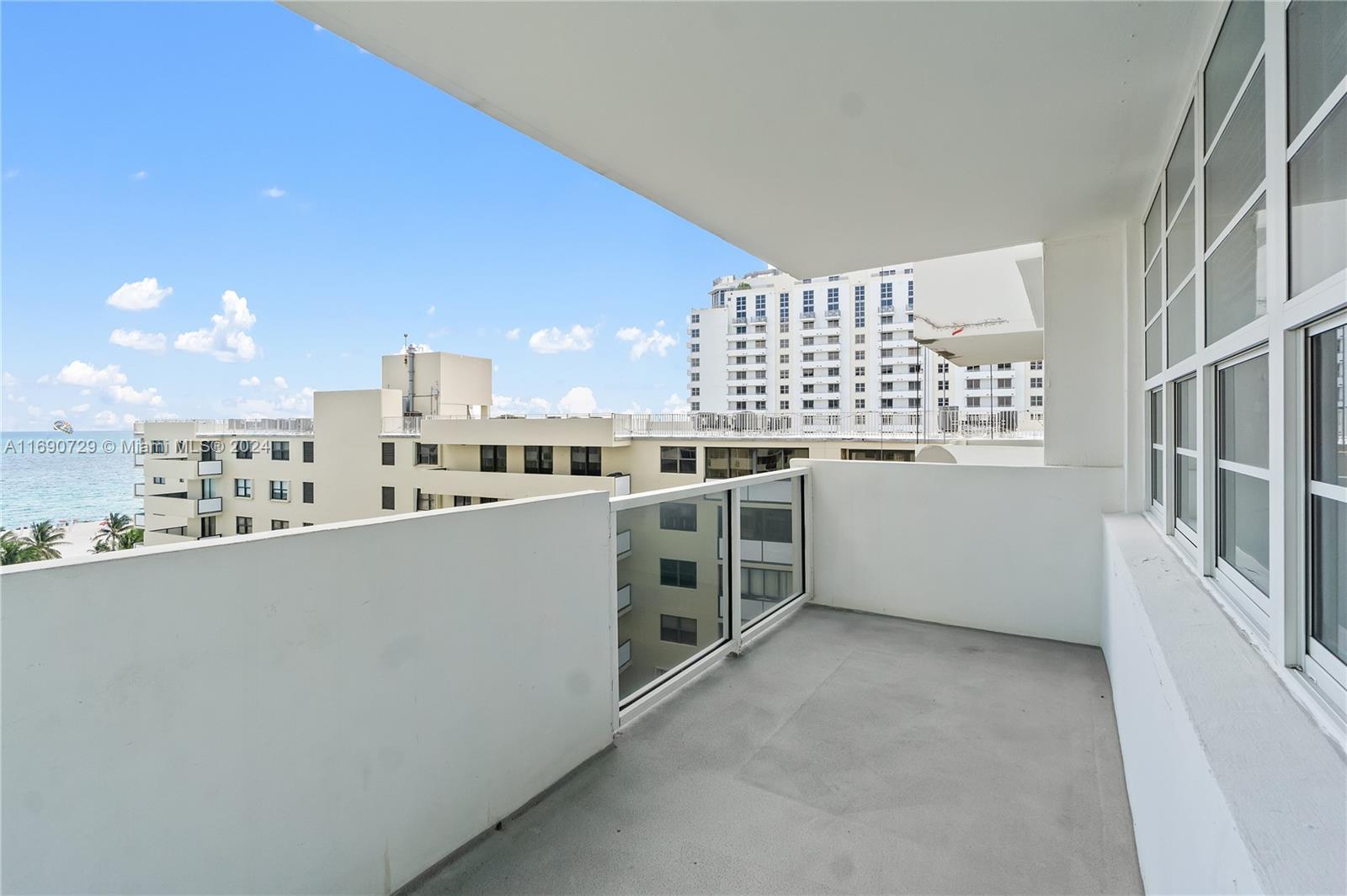100 Lincoln Road, Unit 1019 Miami Beach, FL 33139 - Photo 11 of 16 a view of a kitchen with stainless steel appliances a white stove next to a window