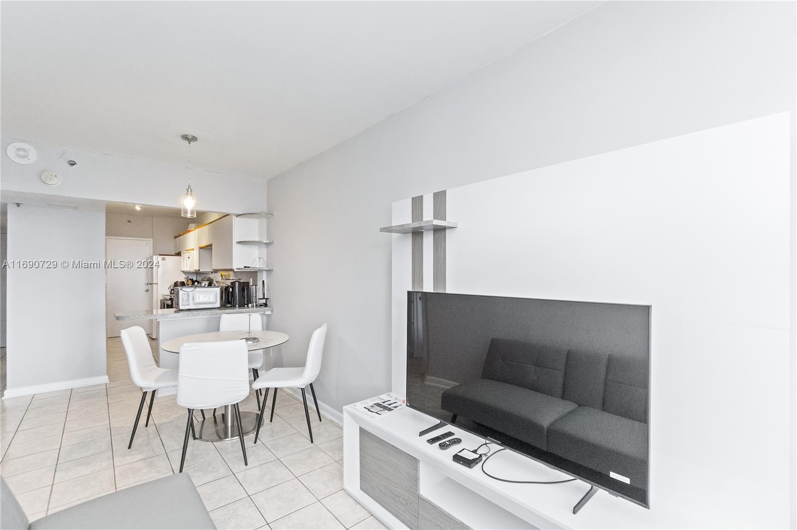 100 Lincoln Road, Unit 1019 Miami Beach, FL 33139 - Photo 3 of 16 a living room with furniture and a table