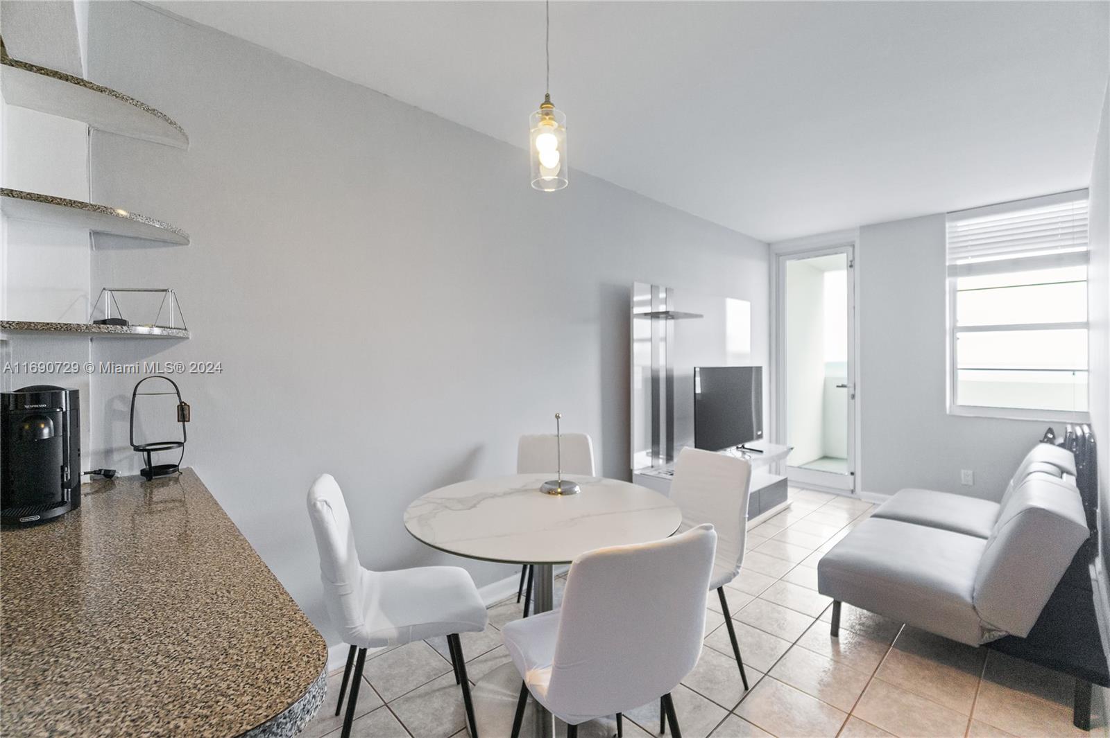 100 Lincoln Road, Unit 1019 Miami Beach, FL 33139 - Photo 4 of 16 a view of a dining room with furniture and wooden floor