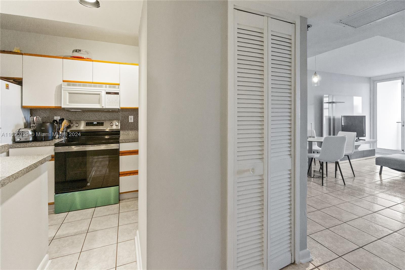 100 Lincoln Road, Unit 1019 Miami Beach, FL 33139 - Photo 7 of 16 a kitchen with stainless steel appliances a stove a sink and a refrigerator