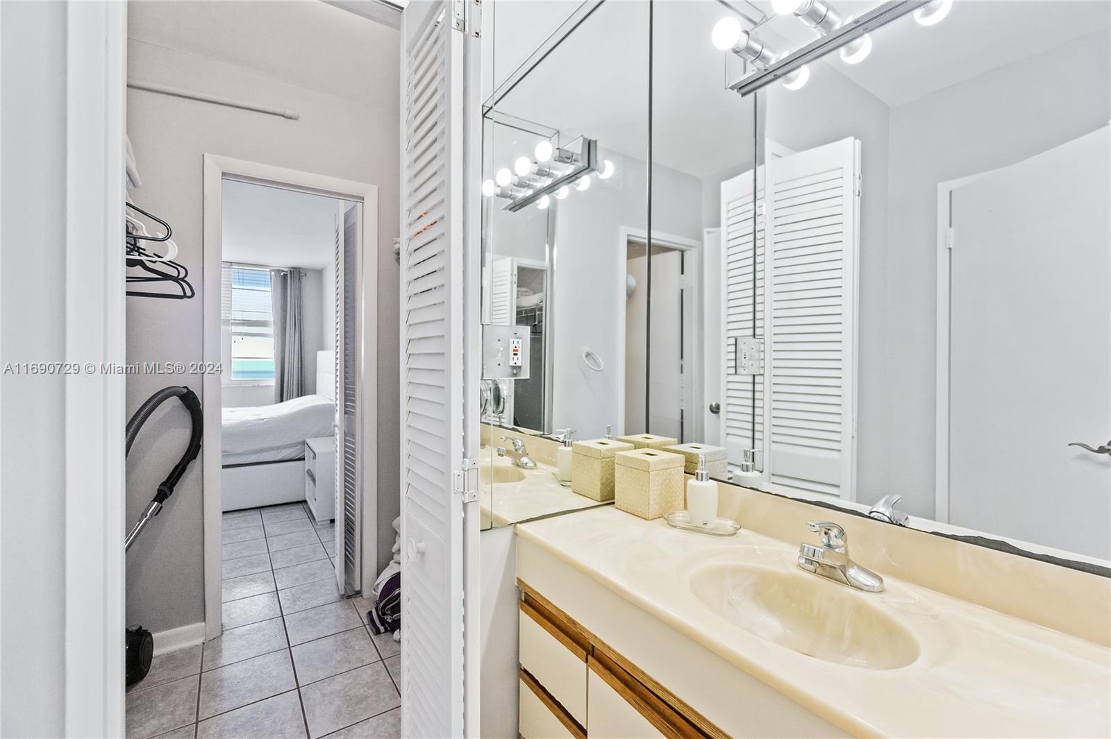100 Lincoln Road, Unit 1019 Miami Beach, FL 33139 - Photo 8 of 16 a en suite bathroom with a double vanity sink and a mirror