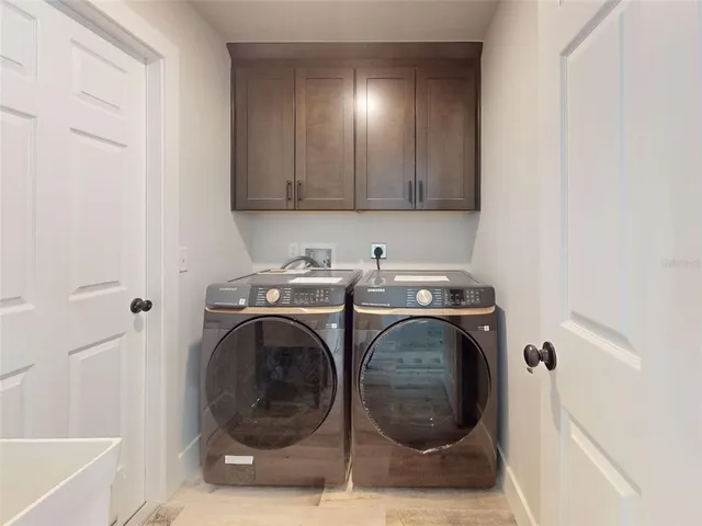an empty room with wooden floor ceiling fan and windows