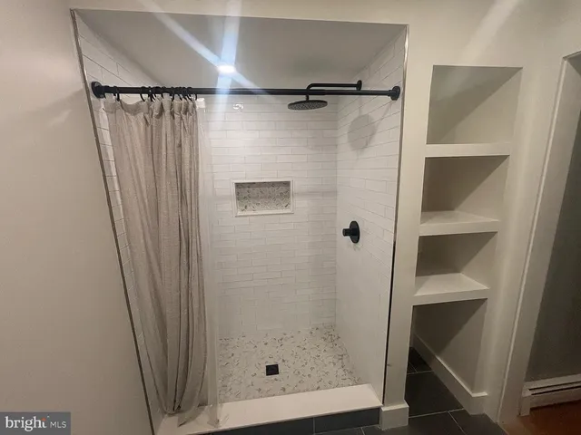 a bathroom with a glass shower door