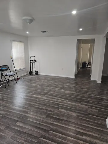 a view of a hallway with wooden floor