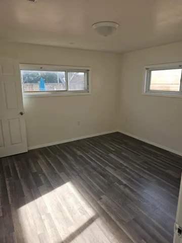 a view of an empty room and wooden floor