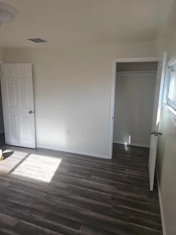a view of a room with wooden floor