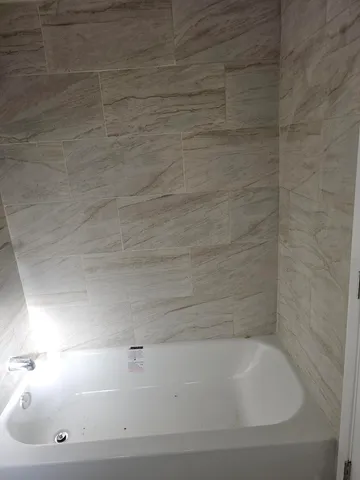 a bathroom with a bathtub and toilet