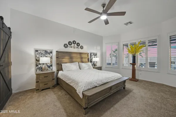 a bedroom with a large bed and a window
