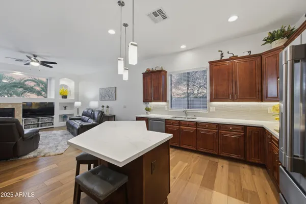 a kitchen with granite countertop a sink appliances and cabinets