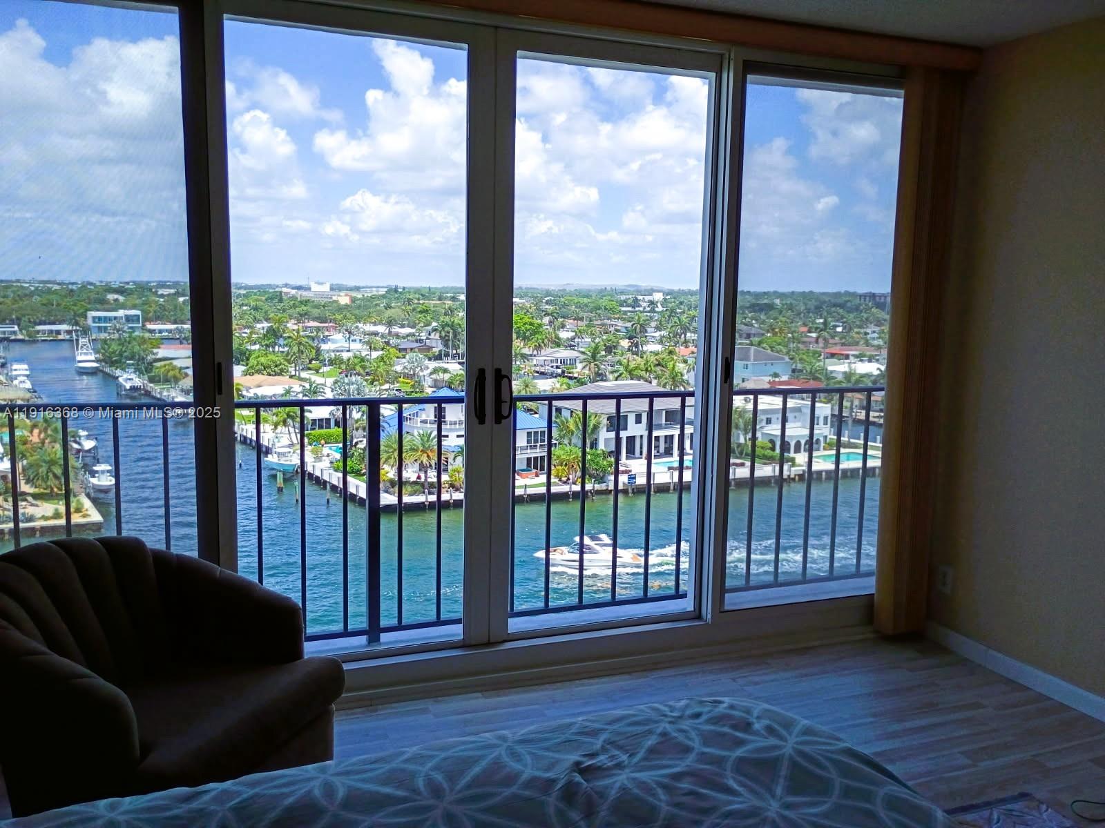 521 North Riverside Drive, Unit 907 Pompano Beach, FL 33062 - Photo 13 of 23 a living room with furniture and a floor to ceiling window