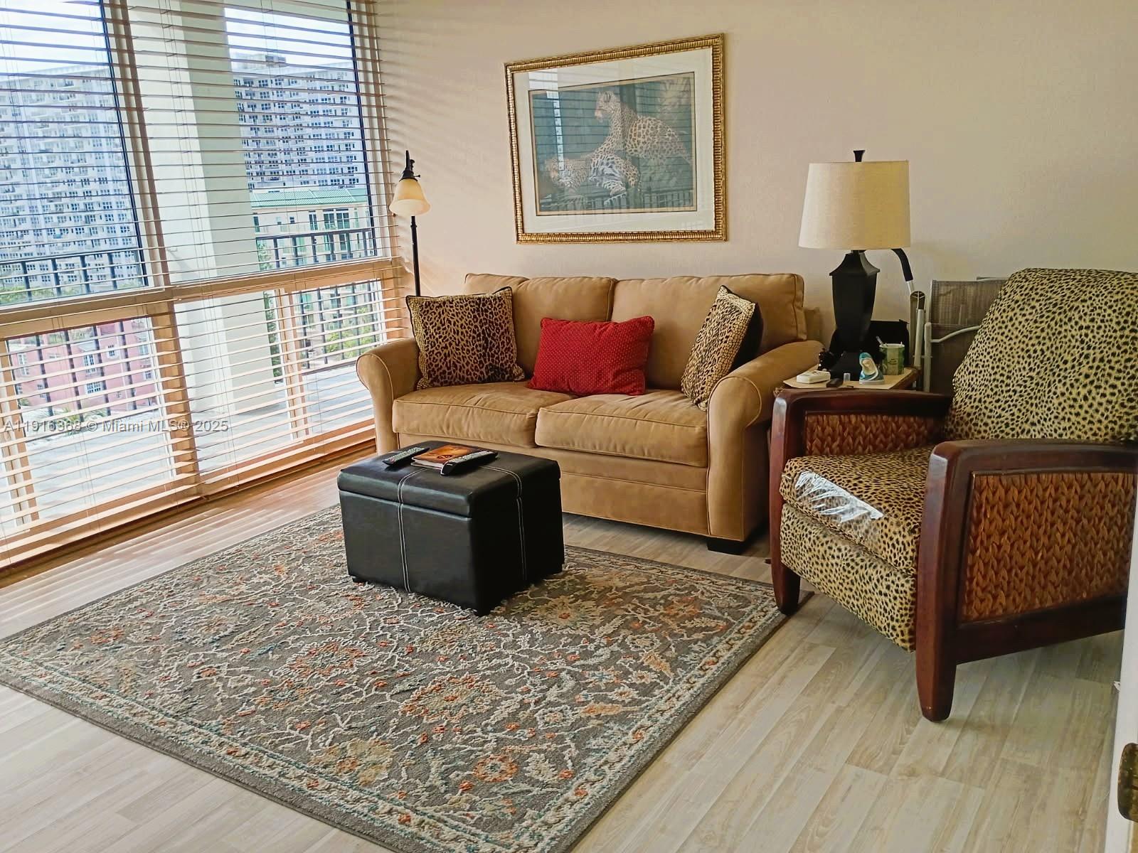 521 North Riverside Drive, Unit 907 Pompano Beach, FL 33062 - Photo 14 of 23 a living room with furniture and a window