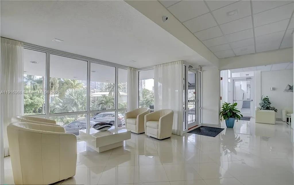 521 North Riverside Drive, Unit 907 Pompano Beach, FL 33062 - Photo 19 of 23 a living room with furniture and a potted plant
