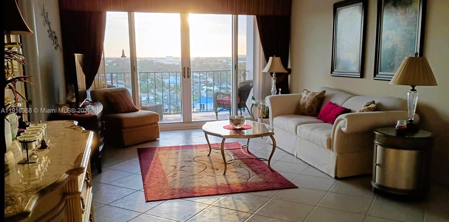 521 North Riverside Drive, Unit 907 Pompano Beach, FL 33062 - Photo 7 of 23 a living room with furniture and a floor to ceiling window