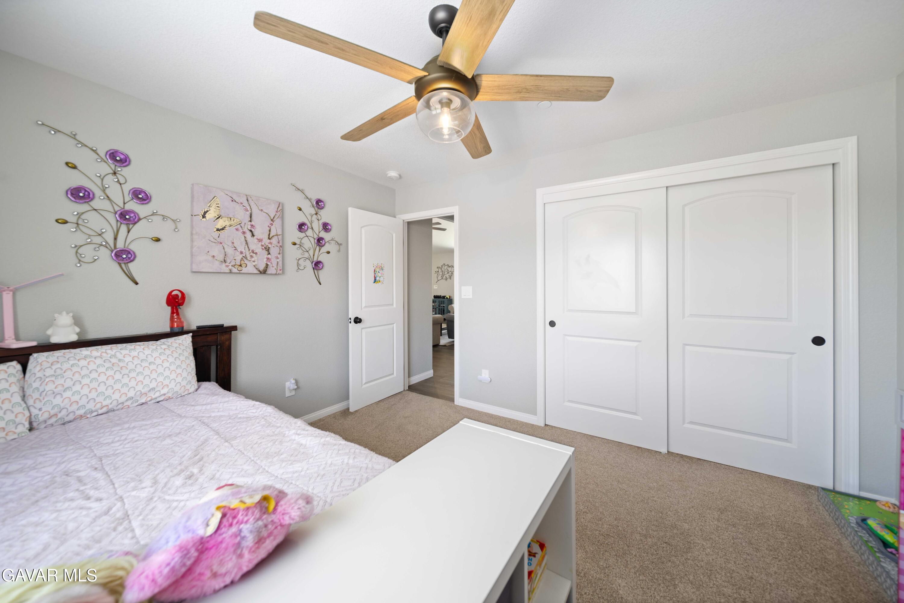 29990 Horsethief Drive Tehachapi, CA 93561 - Photo 21 of 29 a bedroom with a bed and a chandelier