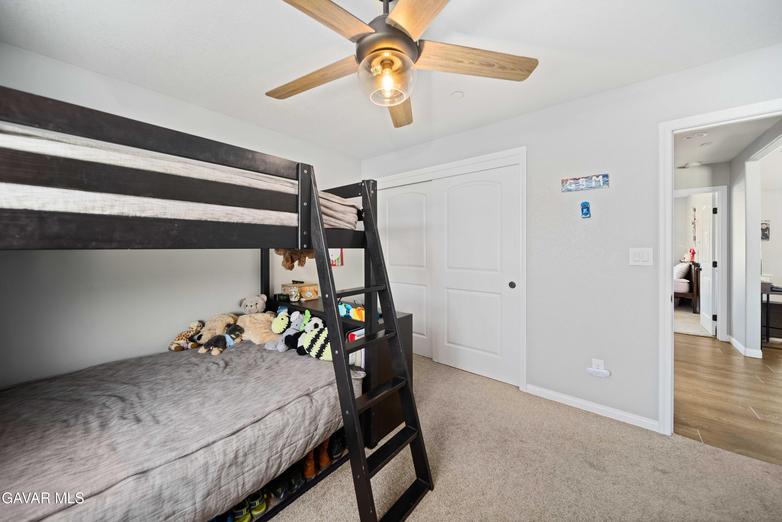 29990 Horsethief Drive Tehachapi, CA 93561 - Photo 23 of 29 a bedroom with a bed and a chandelier