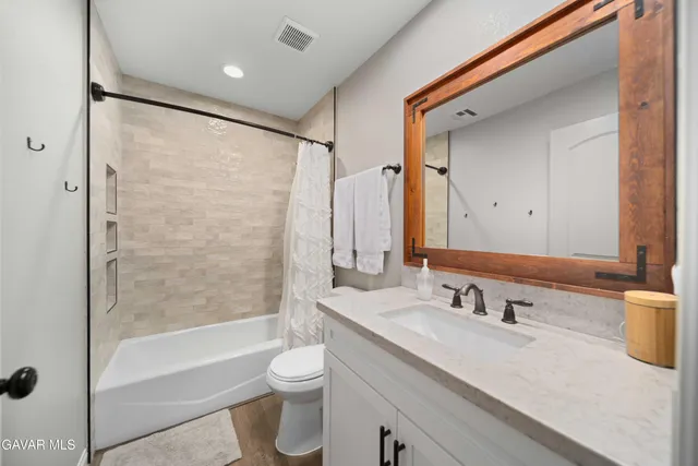 a kitchen with cabinets and wooden floor