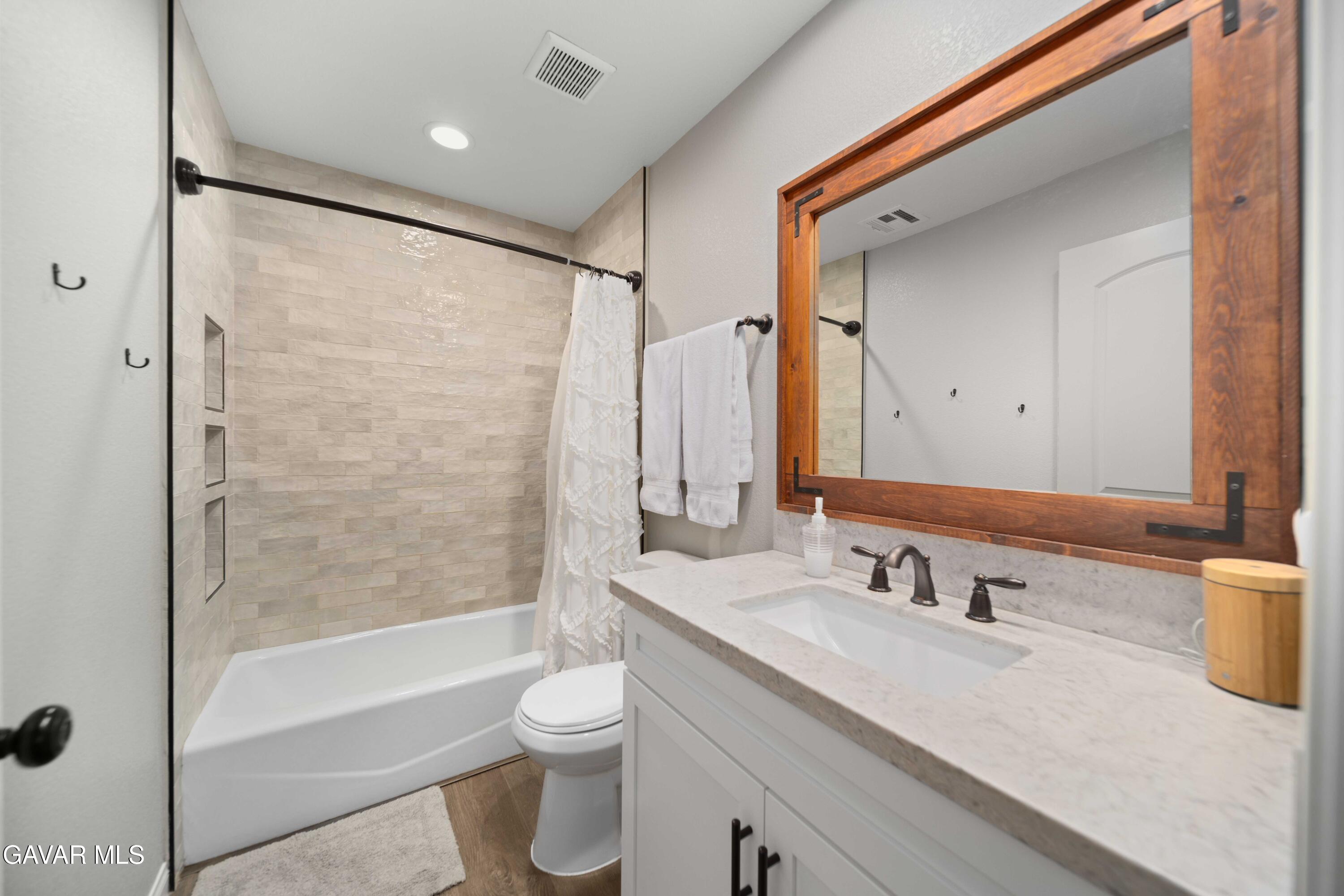 29990 Horsethief Drive Tehachapi, CA 93561 - Photo 24 of 29 a bathroom with a granite countertop sink toilet and shower