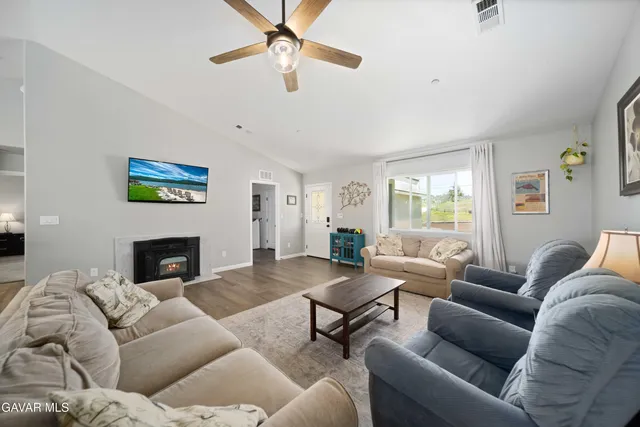 a living room with furniture a fireplace and a window