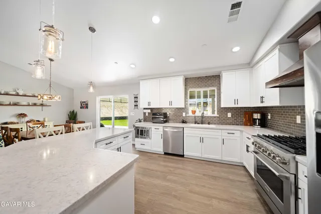 a kitchen with a sink stainless steel appliances and cabinets