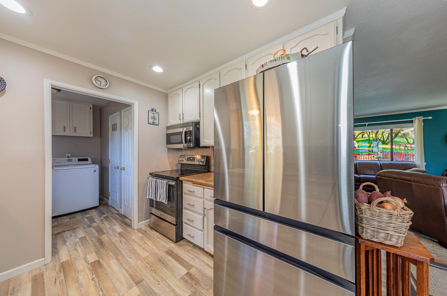 40733 Big Oak Flat Road North Oakhurst, CA 93644 - Photo 12 of 73 a kitchen with stainless steel appliances granite countertop a refrigerator and a stove top oven