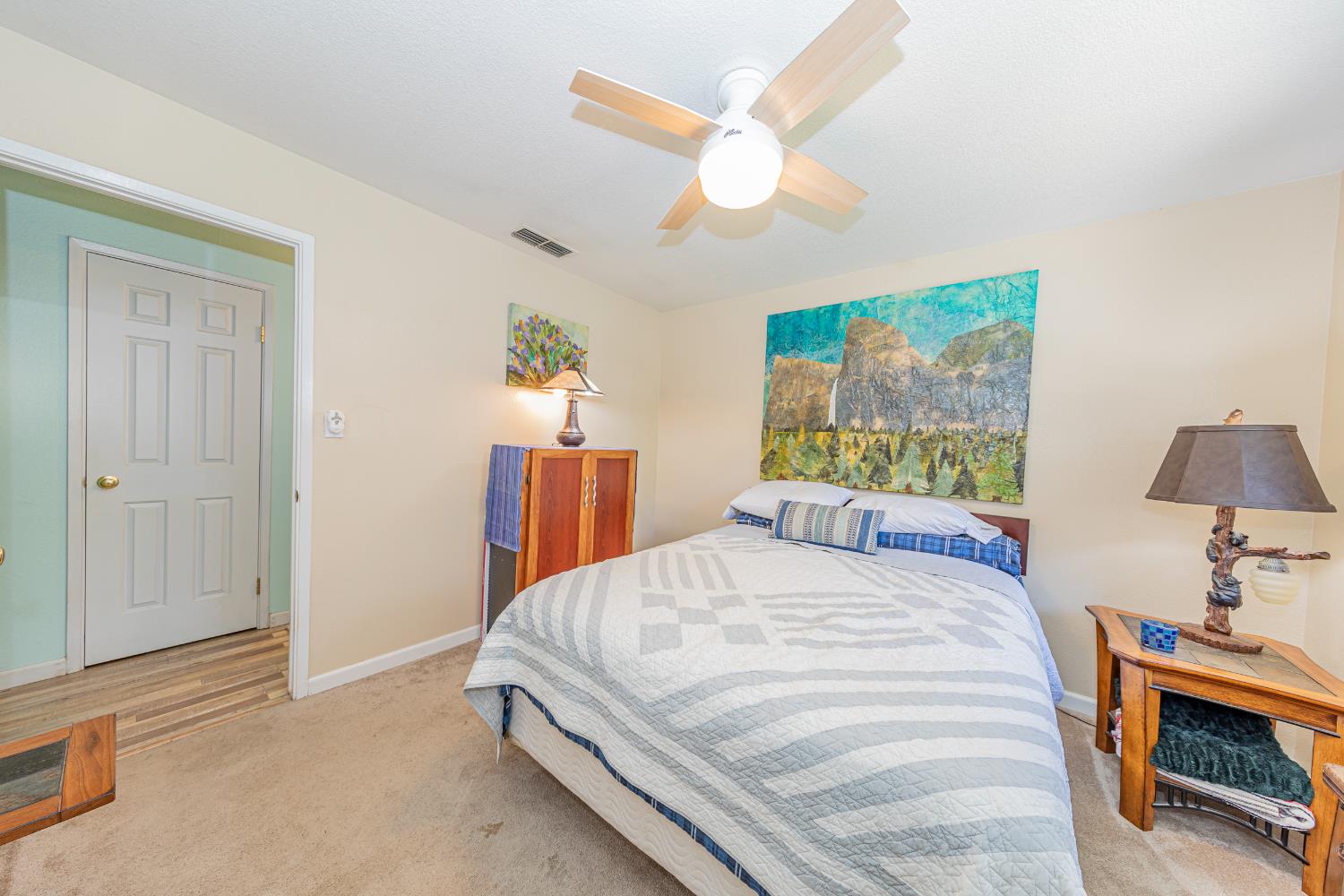 40733 Big Oak Flat Road North Oakhurst, CA 93644 - Photo 24 of 73 a bedroom with a bed and a chandelier