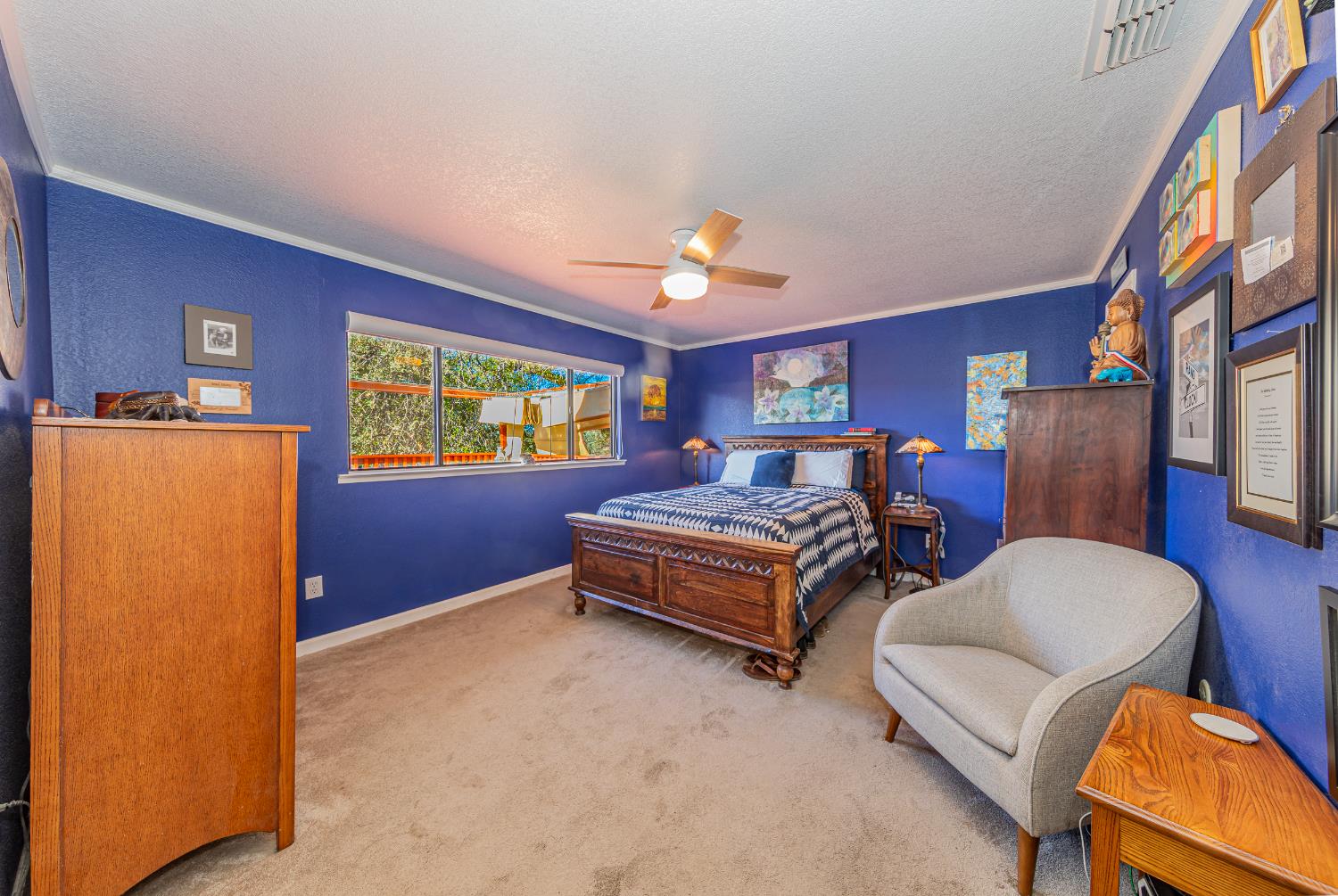 40733 Big Oak Flat Road North Oakhurst, CA 93644 - Photo 28 of 73 a bedroom with a bed and a chandelier