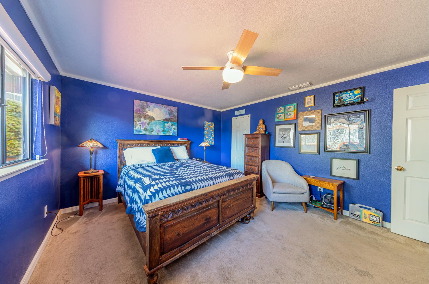 40733 Big Oak Flat Road North Oakhurst, CA 93644 - Photo 29 of 73 a bedroom with a bed and a chandelier