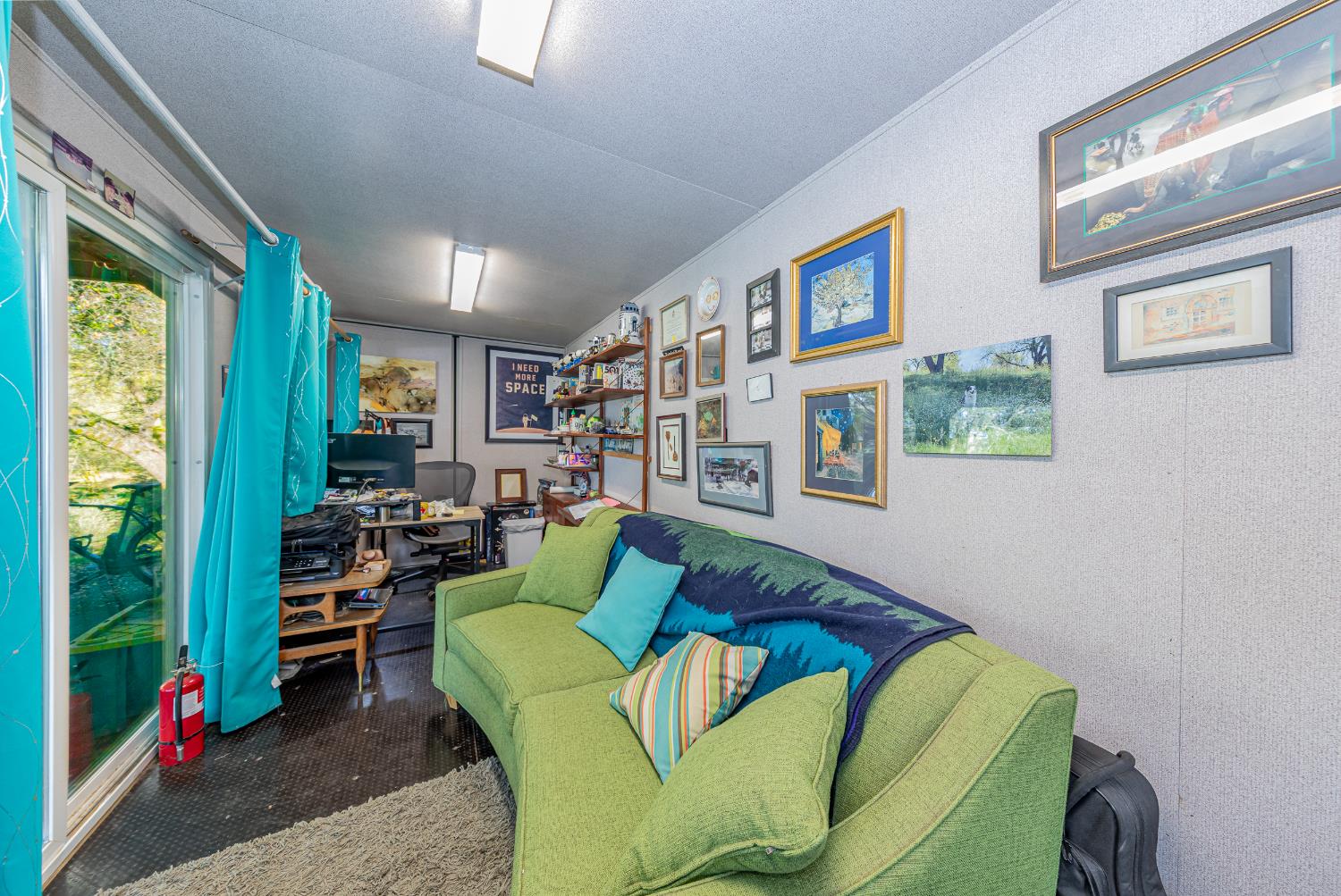 40733 Big Oak Flat Road North Oakhurst, CA 93644 - Photo 38 of 73 a living room with furniture and a bookshelf