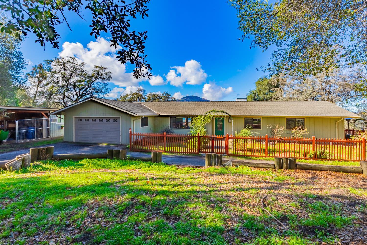 40733 Big Oak Flat Road North Oakhurst, CA 93644 - Photo 47 of 73 a front view of a house with a yard table and chairs