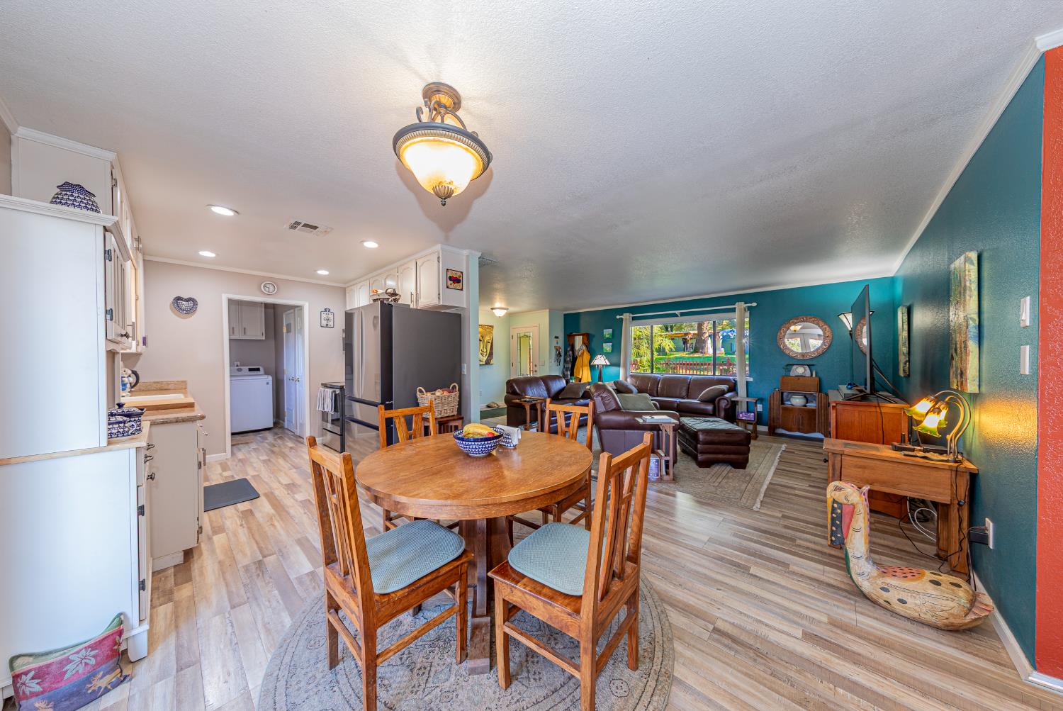 40733 Big Oak Flat Road North Oakhurst, CA 93644 - Photo 10 of 73 a view of a dining room with furniture a rug and wooden floor