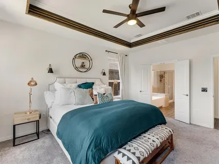 a bedroom with a bed and a chandelier