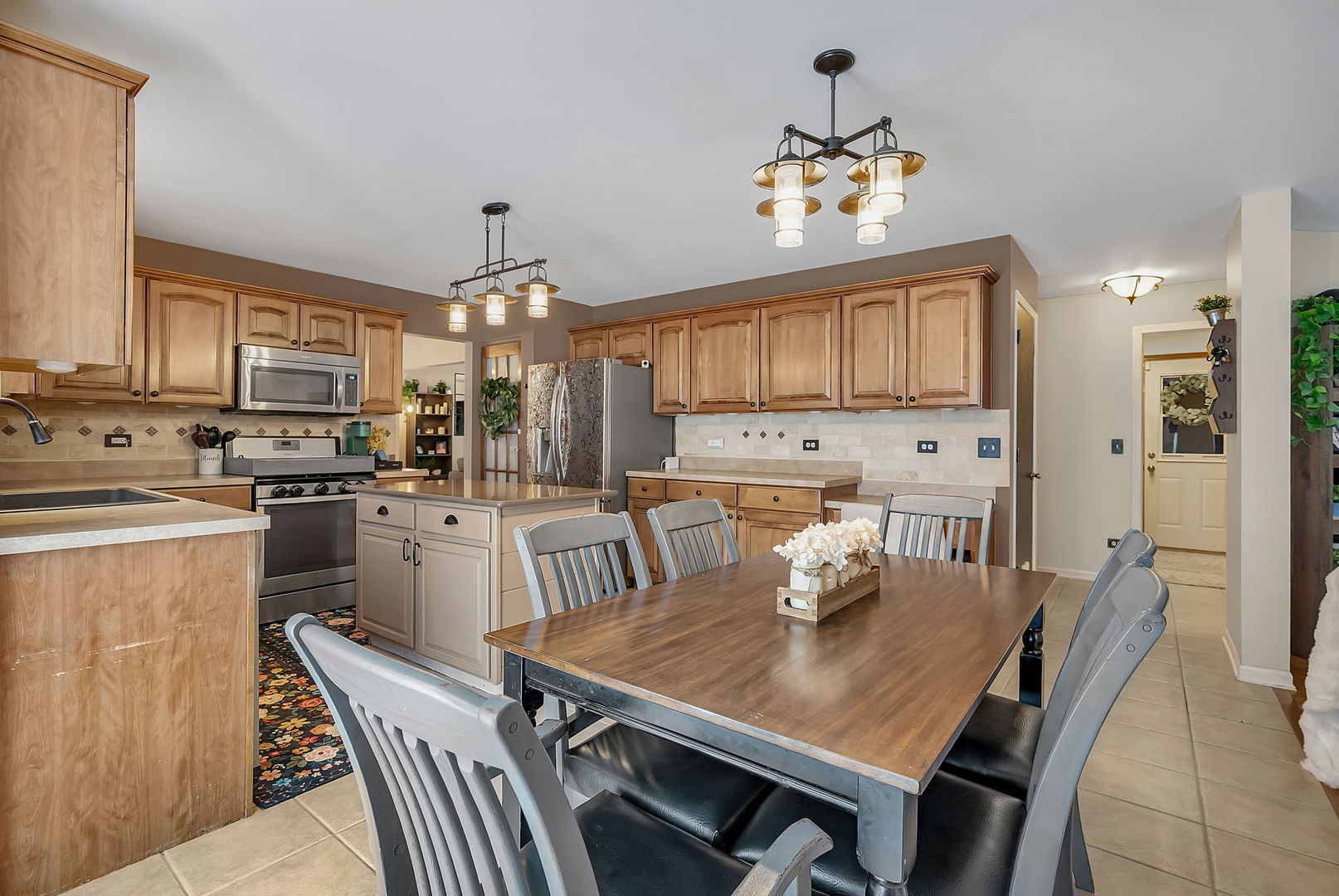 300 Wabena Court Minooka, IL 60447 - Photo 21 of 71 a kitchen with a dining table chairs and refrigerator