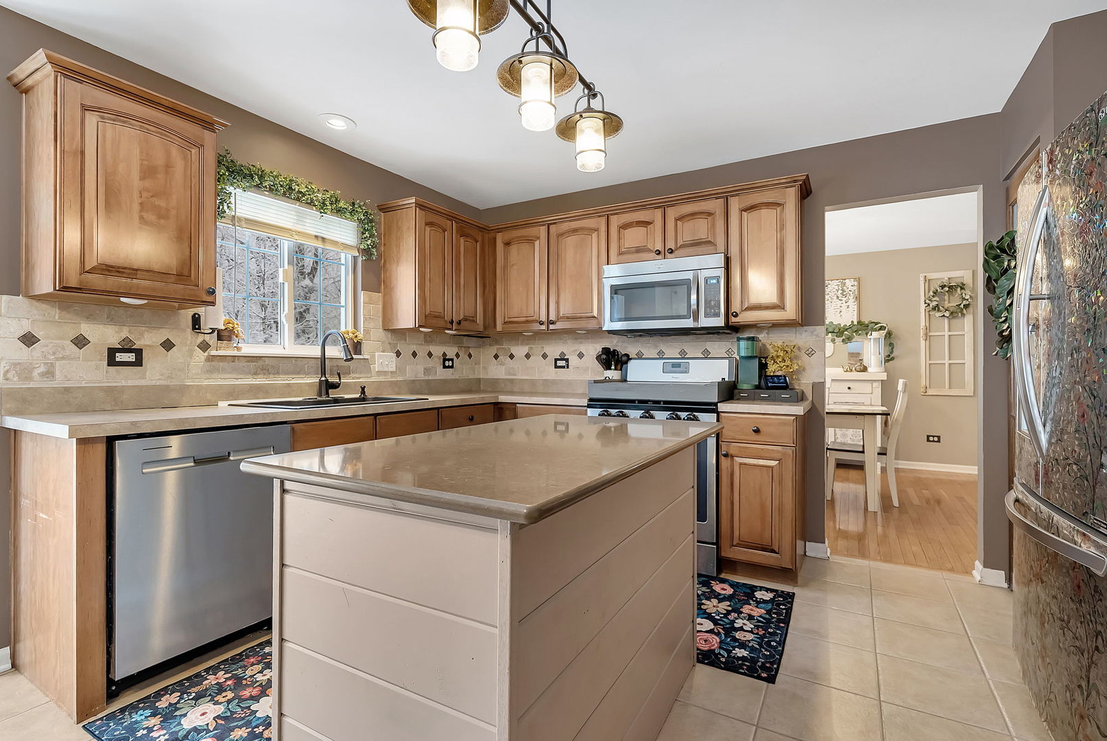 300 Wabena Court Minooka, IL 60447 - Photo 24 of 71 a kitchen with stainless steel appliances granite countertop a sink stove and refrigerator