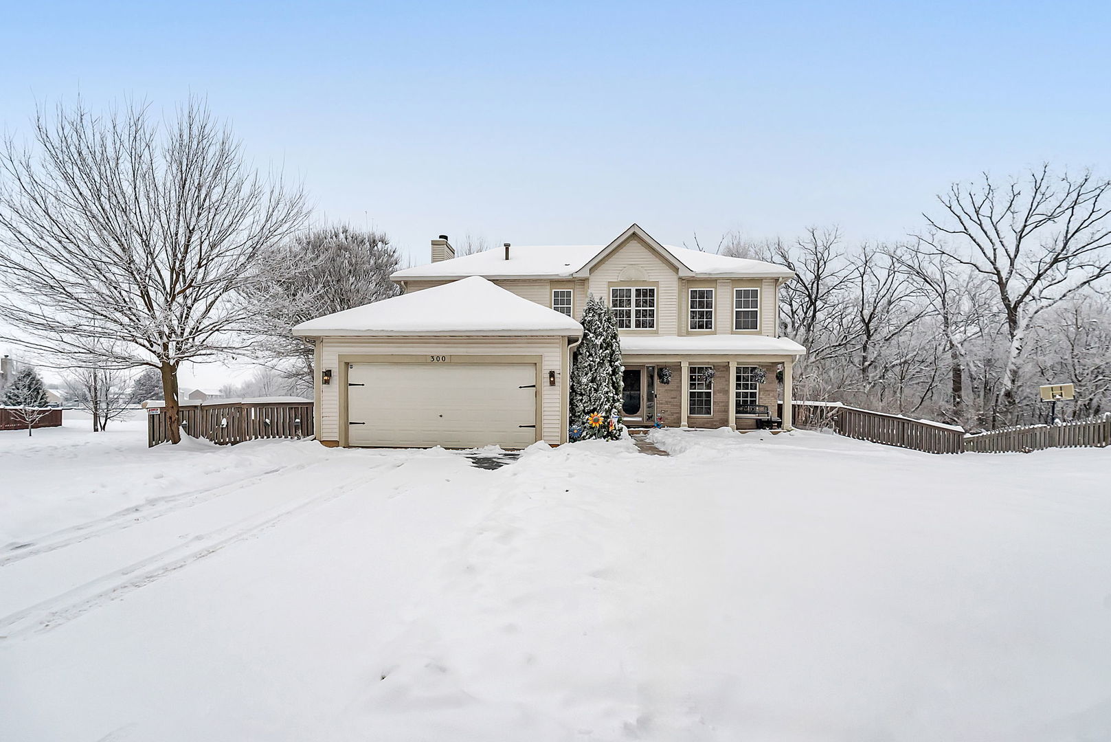 300 Wabena Court Minooka, IL 60447 - Photo 58 of 71 a front view of a house with a yard covered in snow