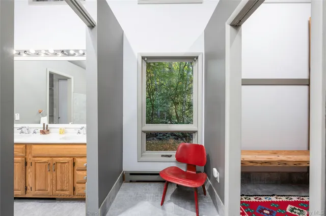 a bathroom with a tub sink and mirror